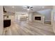Open-concept living room with modern fireplace, sleek floors, and lots of natural light at 2844 Alenga St, Henderson, NV 89044