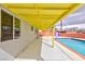 Inviting backyard featuring a swimming pool, patio area, and red brick privacy fence at 3008 Lawndale St, Las Vegas, NV 89121