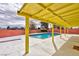 Inviting backyard featuring a swimming pool, patio area, and red brick privacy fence at 3008 Lawndale St, Las Vegas, NV 89121