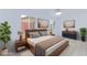Staged bedroom featuring bed with blue throw, dresser, and plants with modern decor at 3008 Lawndale St, Las Vegas, NV 89121