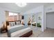 Staged bedroom features a sliding mirror closet, bed with blue throw, and two side tables at 3008 Lawndale St, Las Vegas, NV 89121
