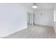 Bright bedroom featuring neutral walls, wood-look floors, closet with mirrored doors, and modern ceiling fan at 3008 Lawndale St, Las Vegas, NV 89121