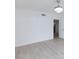 Open bedroom with wood-look floors, a modern ceiling fan, and an open doorway at 3008 Lawndale St, Las Vegas, NV 89121