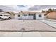 Charming single-story home with a neutral color scheme, gravel landscaping, and shade trees at 3008 Lawndale St, Las Vegas, NV 89121