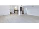 Spacious open-concept living and kitchen area with light floors and white walls at 3008 Lawndale St, Las Vegas, NV 89121