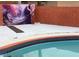 Outdoor pool area featuring a decorative mural backdrop and a brick-lined privacy wall at 3008 Lawndale St, Las Vegas, NV 89121