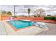 Backyard pool with diving board is surrounded by concrete and enclosed by red brick wall at 3008 Lawndale St, Las Vegas, NV 89121