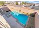 Aerial view showcases a backyard with sparkling pool, lounge chairs, desert landscaping, and privacy fencing at 304 Jolly January Ave, Las Vegas, NV 89183