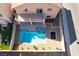 Aerial view of backyard showing a fenced pool, lounge chairs, desert landscaping, and covered patio for outdoor enjoyment at 304 Jolly January Ave, Las Vegas, NV 89183