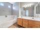 A bright bathroom features double sinks, large mirror and separate tub at 304 Jolly January Ave, Las Vegas, NV 89183