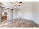 A spacious bedroom with tile floors features an adjacent bathroom and walk-in closet with a barn door at 304 Jolly January Ave, Las Vegas, NV 89183