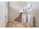 Bright foyer with tile flooring leads to an upper level with carpeted stairs and white railings at 304 Jolly January Ave, Las Vegas, NV 89183