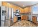 Modern kitchen featuring stainless steel appliances, maple cabinets, and stylish backsplash at 304 Jolly January Ave, Las Vegas, NV 89183