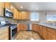 Well-equipped kitchen with stainless steel appliances, granite countertops, and wood cabinetry at 304 Jolly January Ave, Las Vegas, NV 89183