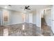 An expansive living room with tile floors and a staircase view offers versatile living space at 304 Jolly January Ave, Las Vegas, NV 89183