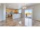 Bright living space showcasing the kitchen, stainless steel appliances, and a sliding glass door to an outdoor balcony at 304 Jolly January Ave, Las Vegas, NV 89183