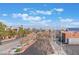 Scenic neighborhood street with lush trees, clear skies and views of the distant city skyline and mountains at 304 Jolly January Ave, Las Vegas, NV 89183