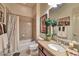 Bathroom with a shower-tub combo, vanity with granite counters, and decorative mirror at 3784 Cheryl Lynne Ct, Las Vegas, NV 89139