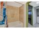 Bright shower and tub with travertine tile surround at 4140 Gannet Cir # 255, Las Vegas, NV 89103