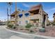 Condo building featuring desert landscaping, blue awnings, and an exterior staircase at 4140 Gannet Cir # 255, Las Vegas, NV 89103