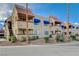 View of the condo complex featuring red tile roofing, blue awnings, and desert landscaping at 4140 Gannet Cir # 255, Las Vegas, NV 89103