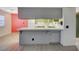 The kitchen bar has tile countertops and gray cabinets at 4140 Gannet Cir # 255, Las Vegas, NV 89103