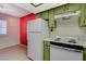 View of the kitchen featuring white appliances and bright green cabinets at 4140 Gannet Cir # 255, Las Vegas, NV 89103