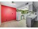 Kitchen featuring white appliances, tiled counters, and cabinetry, accented by a vibrant red wall at 4140 Gannet Cir # 255, Las Vegas, NV 89103