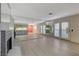Open living area with fireplace, mirrored wall, and access to outdoor balcony through french doors at 4140 Gannet Cir # 255, Las Vegas, NV 89103