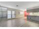 Spacious living room with wood flooring, mirrored wall, and direct access to the kitchen at 4140 Gannet Cir # 255, Las Vegas, NV 89103