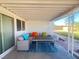 Covered back patio area with outdoor seating and table, perfect for entertaining at 4194 Greenpoint St, Las Vegas, NV 89147