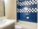 Bathroom with blue and white checkered tile surrounding the tub and shower at 4194 Greenpoint St, Las Vegas, NV 89147