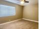 Bright bedroom with wood-look tile flooring and ceiling fan fixture at 4194 Greenpoint St, Las Vegas, NV 89147