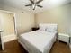 Bedroom features wood flooring, a ceiling fan with lights, and matching nightstands at 4194 Greenpoint St, Las Vegas, NV 89147