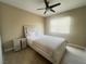 Bedroom features light-colored walls, wood flooring, a ceiling fan, and a nightstand at 4194 Greenpoint St, Las Vegas, NV 89147