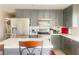 Modern eat-in kitchen featuring stainless steel appliances and updated gray cabinets at 4194 Greenpoint St, Las Vegas, NV 89147