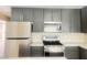 Close up of a stainless steel range, microwave, and refrigerator at 4194 Greenpoint St, Las Vegas, NV 89147