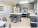 Modern kitchen with stainless steel appliances, gray cabinets and island with seating at 4194 Greenpoint St, Las Vegas, NV 89147
