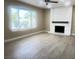 Spacious living room with a large window and a painted brick fireplace at 4194 Greenpoint St, Las Vegas, NV 89147