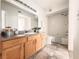 Well-lit bathroom featuring a vanity with a mirror, toilet, and a shower-tub combo at 45 Maleena Mesa St # 327, Henderson, NV 89074