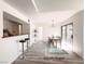 Bright dining room area with a modern table set, access to outdoor balcony, and bar seating into the kitchen at 45 Maleena Mesa St # 327, Henderson, NV 89074