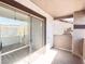 View of the covered patio with stucco walls and concrete flooring from inside the unit at 45 Maleena Mesa St # 327, Henderson, NV 89074