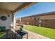 Cozy backyard with covered patio and manicured artificial turf at 4743 S Sungold St, Pahrump, NV 89061