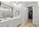 Modern bathroom featuring double sinks, walk-in shower and closet at 4743 S Sungold St, Pahrump, NV 89061