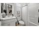 Clean, white bathroom with a vanity, toilet, and shower-tub combination, complemented by neutral decor at 4743 S Sungold St, Pahrump, NV 89061