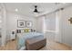 Bright bedroom featuring wood floors, ceiling fan, and neutral decor at 4743 S Sungold St, Pahrump, NV 89061