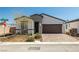 Charming single-story home featuring a landscaped front yard and a two-car garage with a brick-paved driveway at 4743 S Sungold St, Pahrump, NV 89061