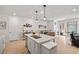 Open-concept kitchen with island, bar seating, and stainless steel sink at 4743 S Sungold St, Pahrump, NV 89061
