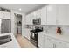 Well-lit kitchen features modern appliances, white cabinets, and access to laundry area at 4743 S Sungold St, Pahrump, NV 89061