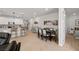 Bright open floorplan with kitchen featuring barstool seating, adjacent dining, and access to bedroom at 4743 S Sungold St, Pahrump, NV 89061